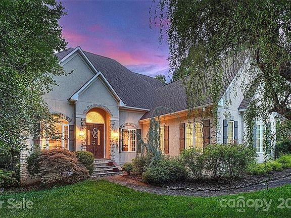 Looks like a small castle. Large driveway and 3 car garage.