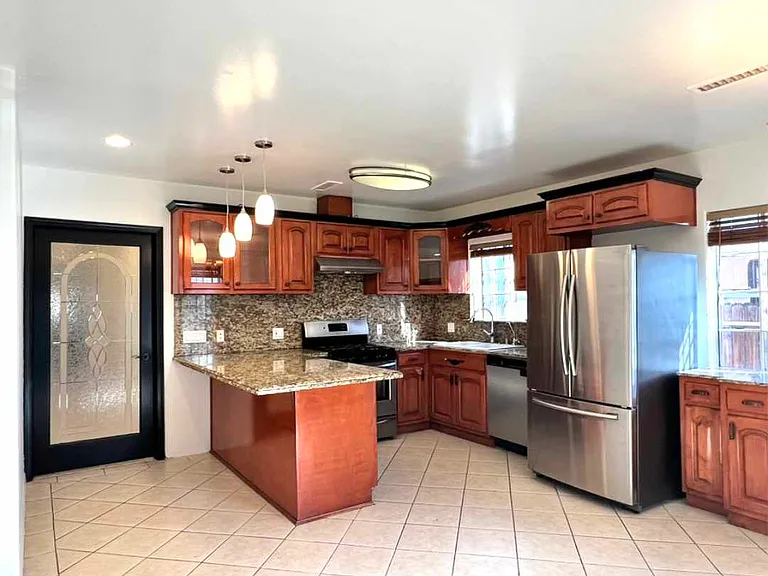 View from main entrance to kitchen and doored entry to living area.