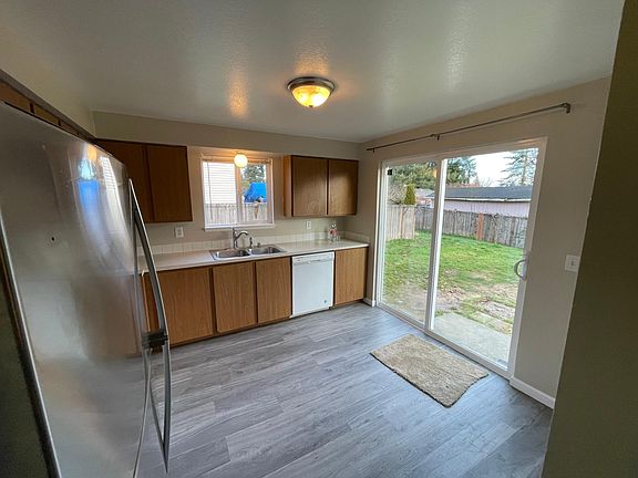 Kitchen has a sliding door to fully fenced backyard