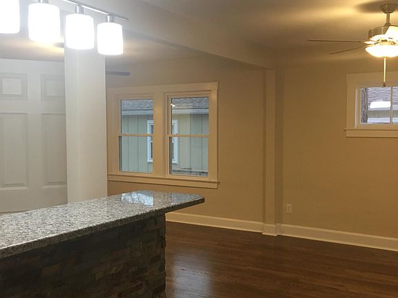 View of kitchen island and living room with hardwood floor