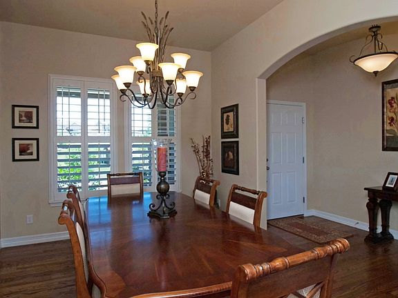 Large dining room with plantation shutters and lighted niche