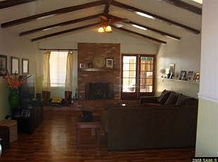 Sunken living Room with Exposed Wood Beams