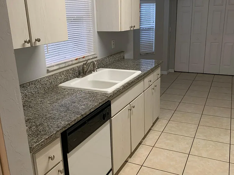 Kitchen with granite countertops looking into the dining room