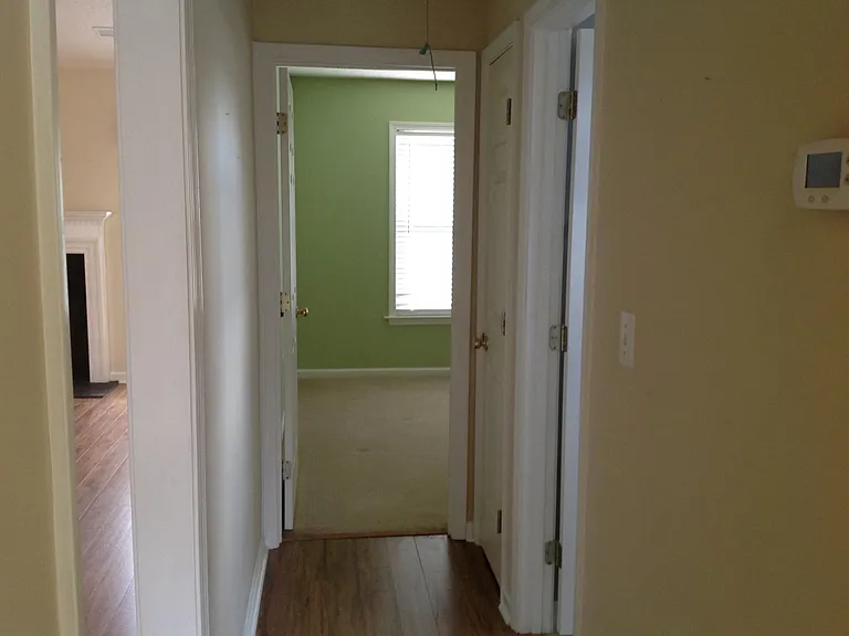 Far side of living room hallway with linen closet and full bath serving BR #2,#3 (green room is now a light gray paint, shown as a girl's room in next photos).