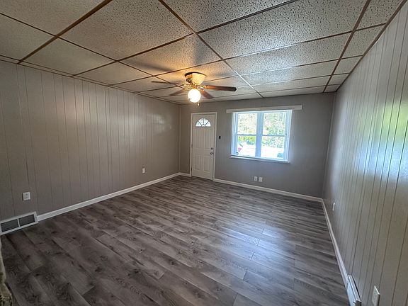 Living Room with new flooring, paint, outlets and ceiling fan.