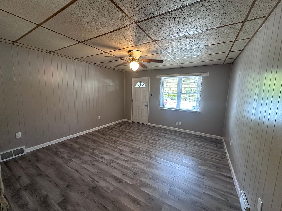 Living Room with new flooring, paint, outlets and ceiling fan.