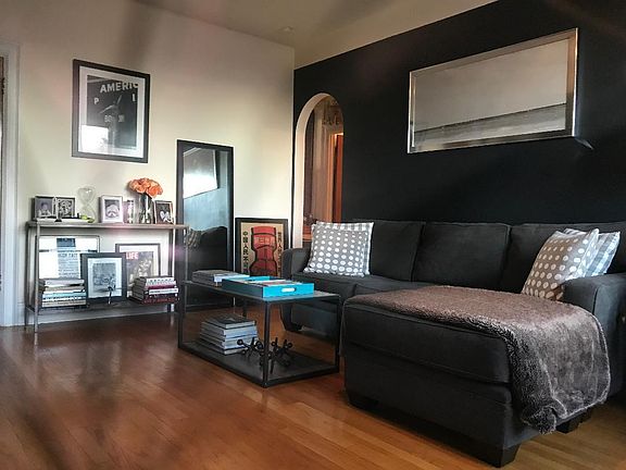 Living room with archway entrance to the bedroom and bathroom