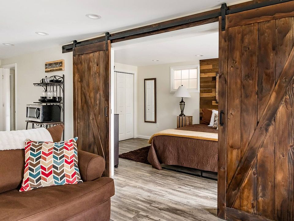 The fifth bedroom offers a serene escape, featuring direct walkout access ideal for enjoying peaceful early mornings and capturing breathtaking sunrise views.
