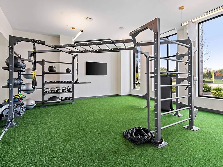 Free weights and bodyweight training in the 24/7 fitness center at The Hallon Luxury Apartments in Hopkins MN | apartments near St Louis Park MN