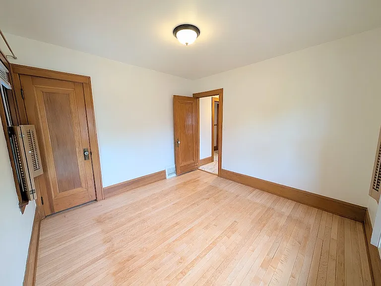 [UPPER UNIT]: second bedroom with newly refinished maple flooring