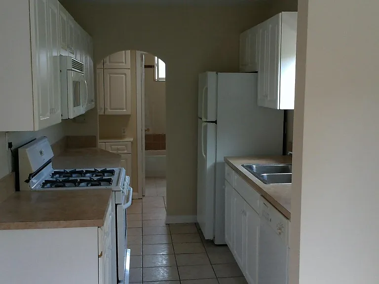 White galley style kitchen with dishwasher