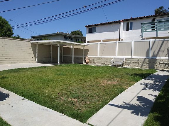 large back yard with covered patio