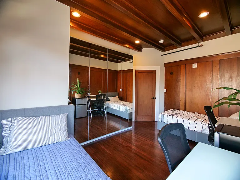 A thoughtfully designed bedroom with hardwood floors, cozy beds, and workspace for you. A thoughtfully designed bedroom with hardwood floors, cozy beds, and workspace for you.