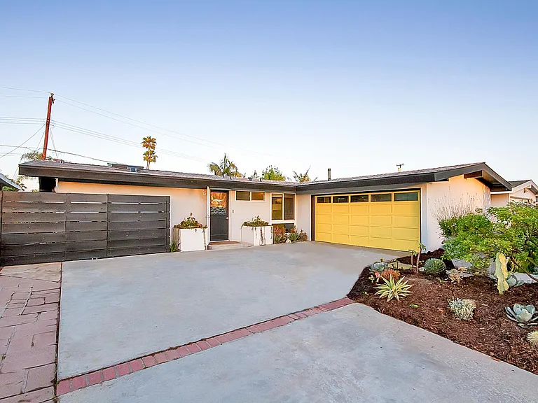 2-car garage, hide-away trash storage & side gates.