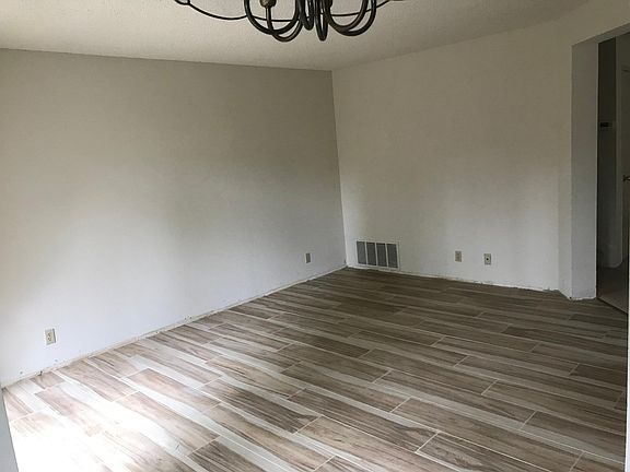 Family room with hardwood-look tile for easy cleaning.