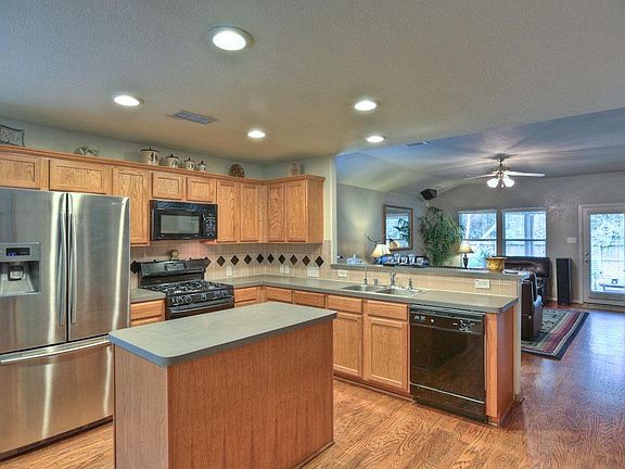 Island kitchen with bar to family room is great for entertaining!