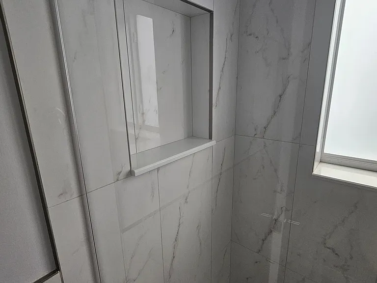 Convenient shower nook for shampoo and etcetera.