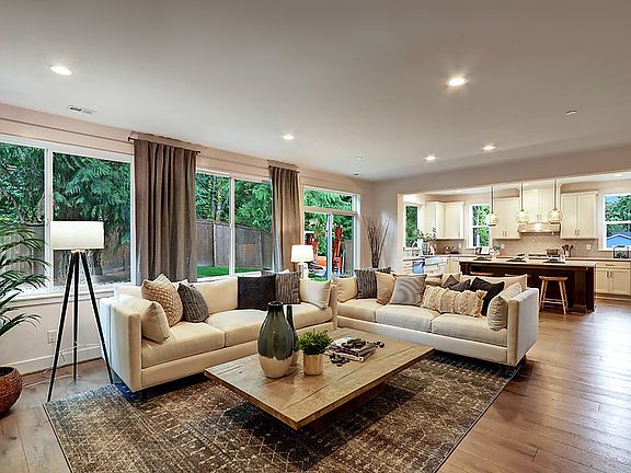 Large great room extends to open kitchen with lots of natural light