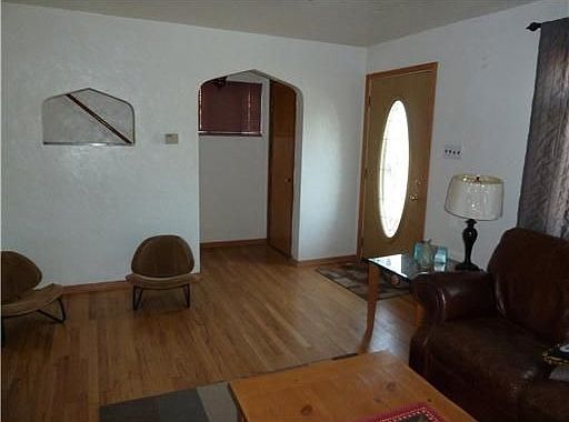 A second view of the living room shows the unique doorway detail