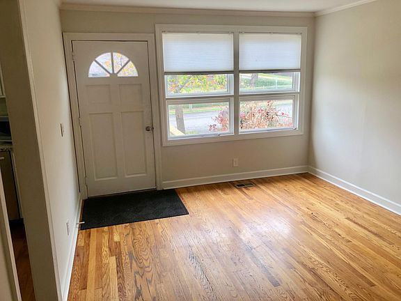 Living room with hardwood floors, large windows, and cable ready.