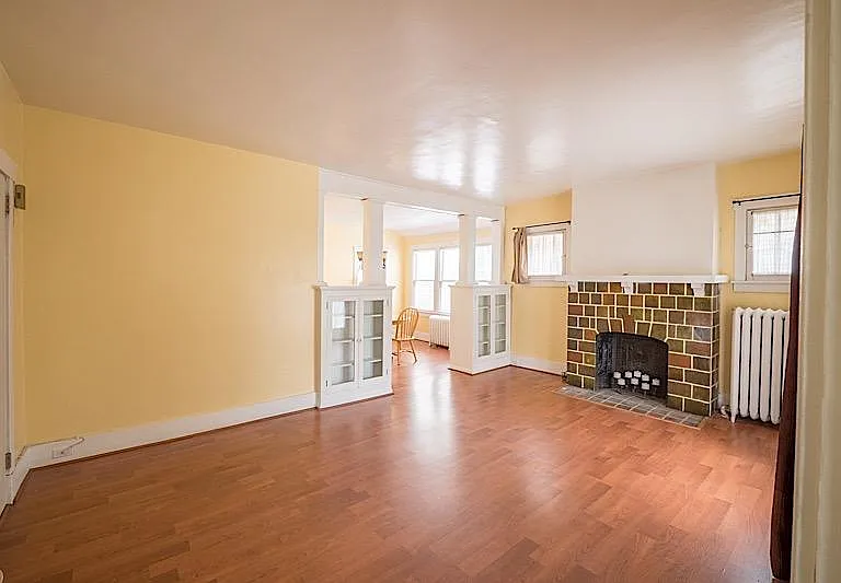 Spacious and elegant Living room with deco Fire Place brigt and light. Beautiful hard wood floors.