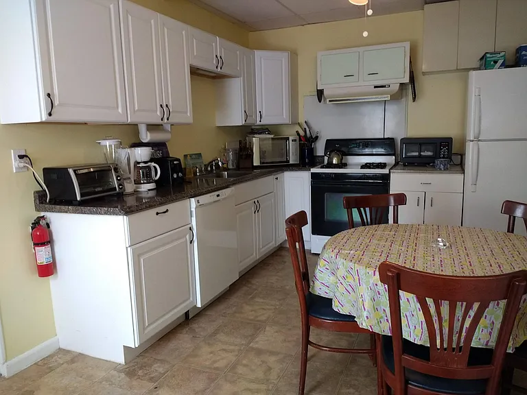 Eat-in kitchen has gas range, large fridge with ice-maker, and dishwasher.