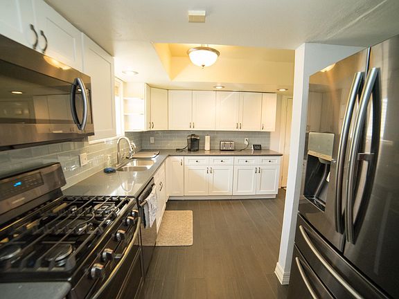 Luxurious kitchen with new stainless steel Samsung appliances, quartz countertop and tons of storage space!