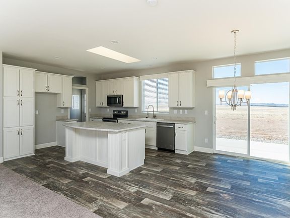 Kitchen - Solid wood cabinets, upgraded nickel hardware, title back splashes, highly upgraded stainless appliance package, center island,  country farm sink with pull out faucet, skylight, recessed lighting.