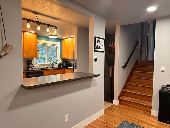 Pass-through from living space into kitchen, stairs to bedrooms and bathroom