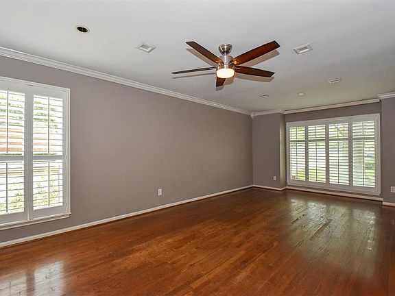 Large spacious area with gleaming wood floors.