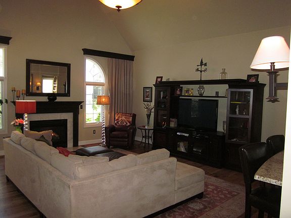 Living Room with atrium windows, pendant light and ceiling fans.