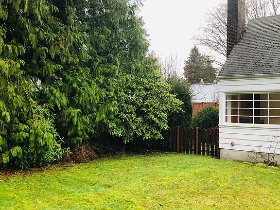 Large front yard with gated side yard.