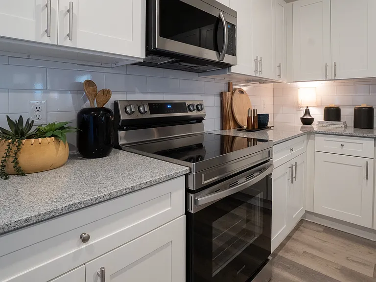 Chef-inspired kitchen with granite countertops and stainless steel appliances.