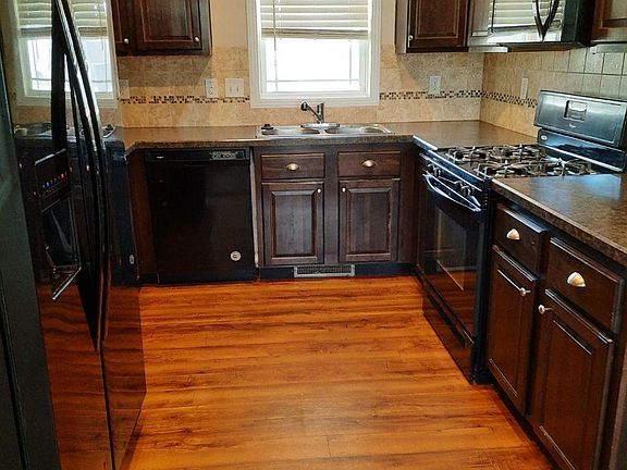 Impressive kitchen features abundant cabinet storage, microwave, gas range/electric oven, dishwasher and refrigerator with water and ice maker.