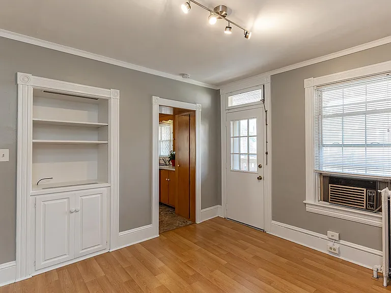 Dining room, with built-in hutch, new light fixture, and door to roofdeck.