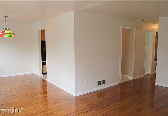 View of living room/dining room and kitchen entrances from a