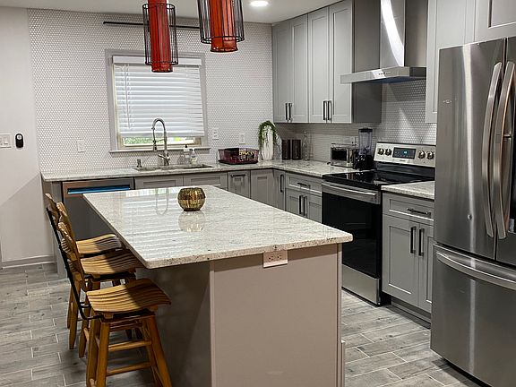 Chef-inspired kitchen featuring stainless steel appliances and clean, modern finished