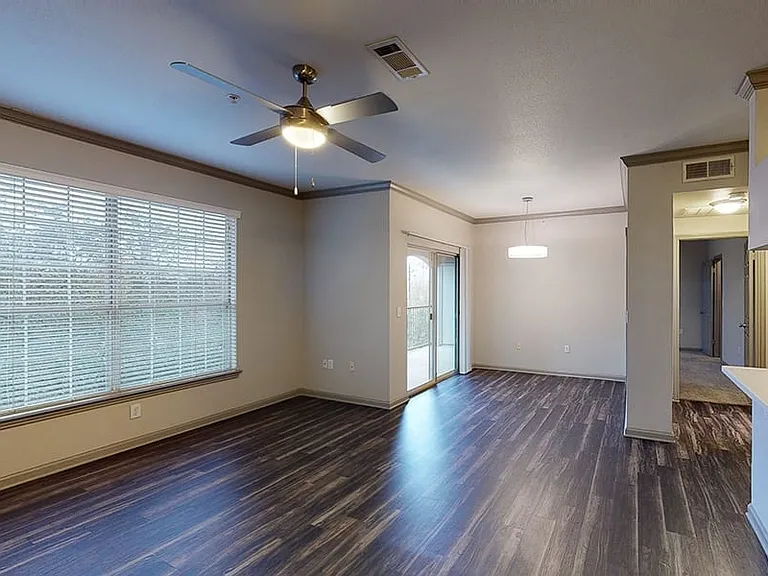 Apartment living room with wood-style flooring and patio or balcony.