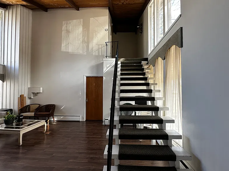 Enter the building into a common space. Stairs lead to the condo.