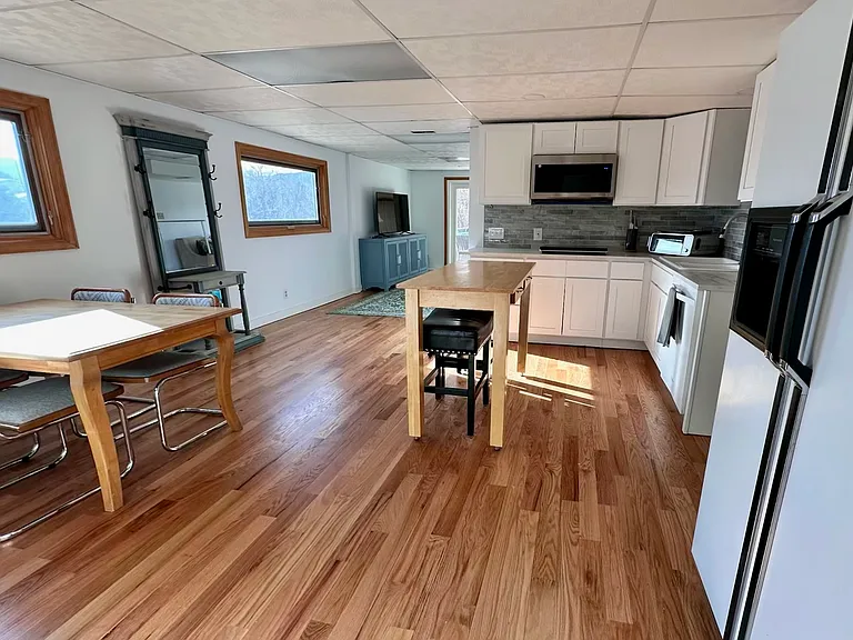 Kitchenette with full-sized fridge, dishwasher, built-in MW with convection oven, 10-in-one Ninja air-fryer/toaster oven, 2 burner induction cooktop. Island seating.
