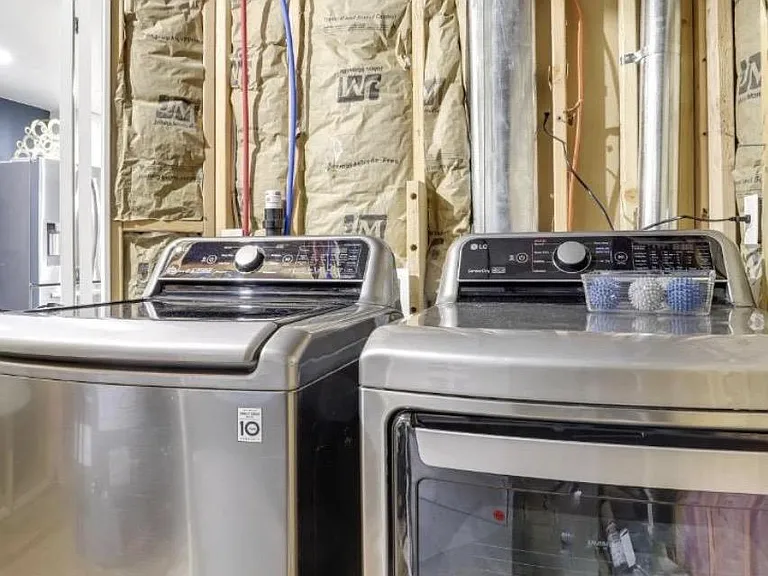 Dedicated laundry area with full-size washer and dryer for convenient in-home laundry.