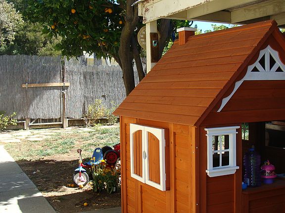 Covered patio and extra storage (playhouse does not stay)