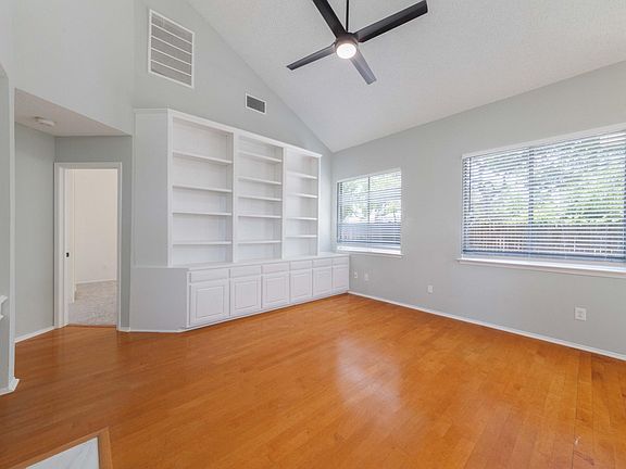 family room with plenty of built-in storage space. natural light with high ceiling.