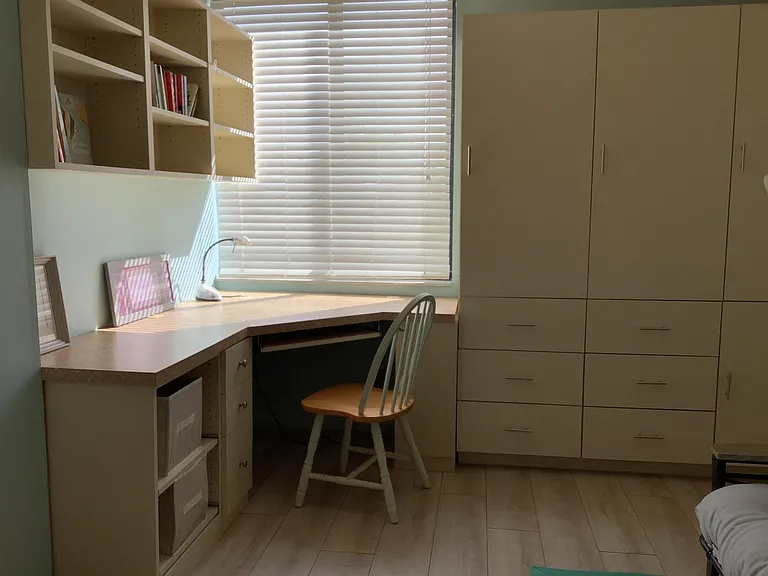 Desk and plenty of storage cabinets in guest bedroom/office