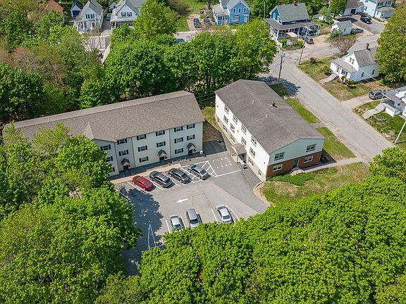 Aerial view of both buildings and parking lot