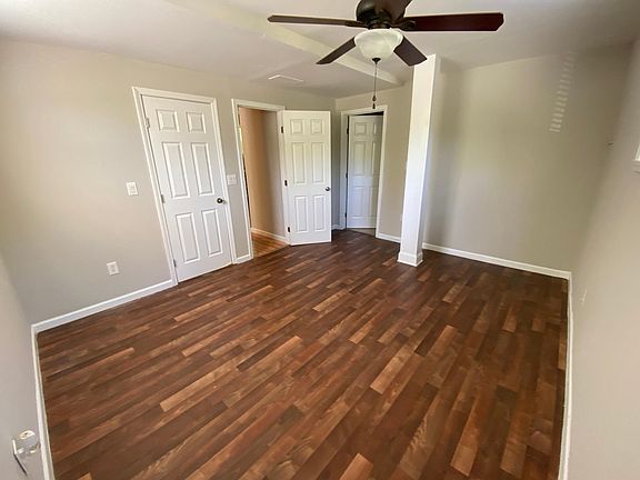 Master bedroom with windows & laminate vinyl flooring. Room measures 11.5' x 14'