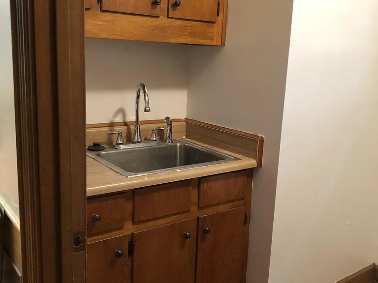 Laundry Room Sink area. Lots of storage space. Wire Shelves all around top of room