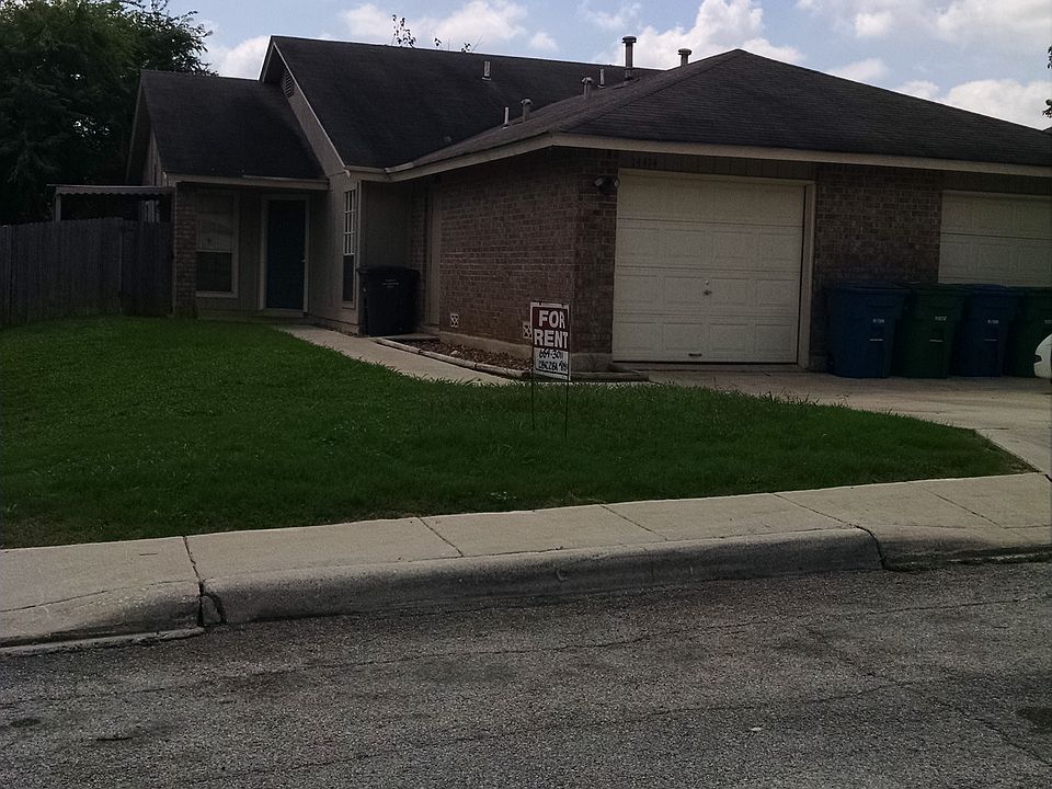 FRONT OF DUPLEX, GARAGE AND PRIVATE ENTRANCE.