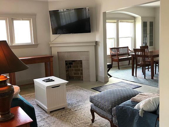 Comfortable living room features smart TV & blackjack game table.