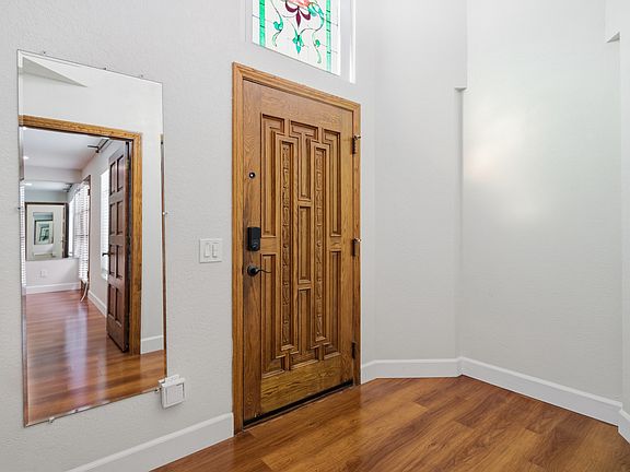 Front entry with stained glass above door and wood paneled ceiling
